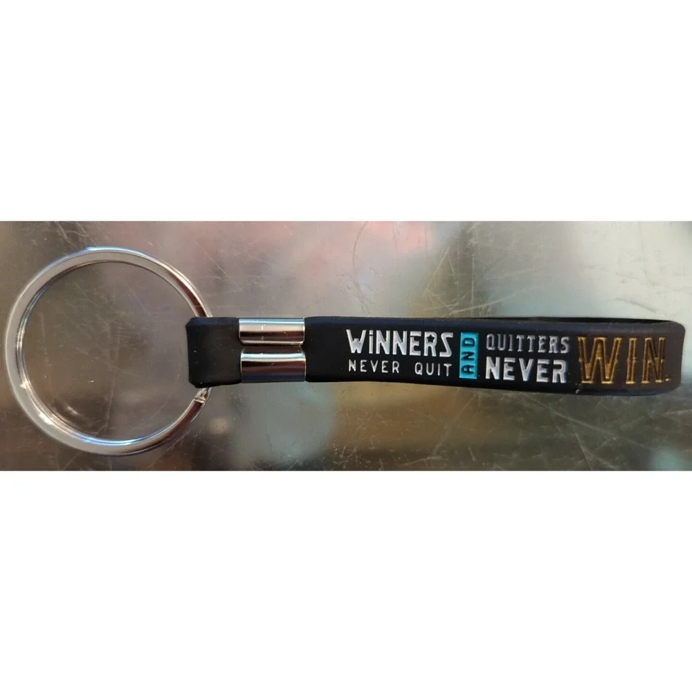 Brand New Inkstone Hockey Winners Never Quit Silicone Rubber Keychain Bracelet